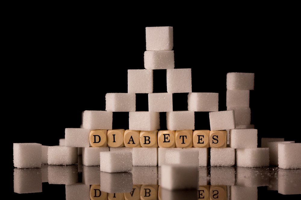 Sugar cubes stacked on black background